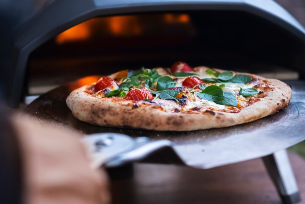 A,Pizza,Margarita,With,Fresh,Basil,Leaves,On,The,Background