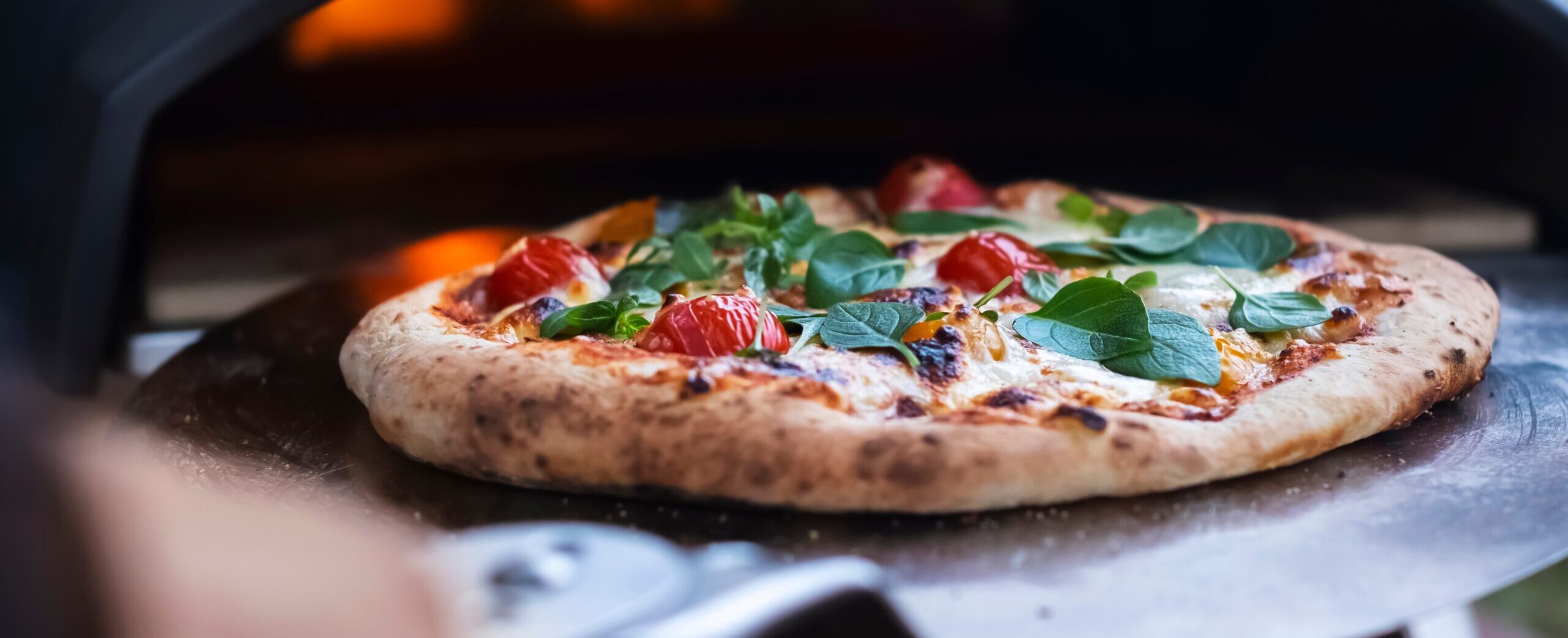 A,Pizza,Margarita,With,Fresh,Basil,Leaves,On,The,Background